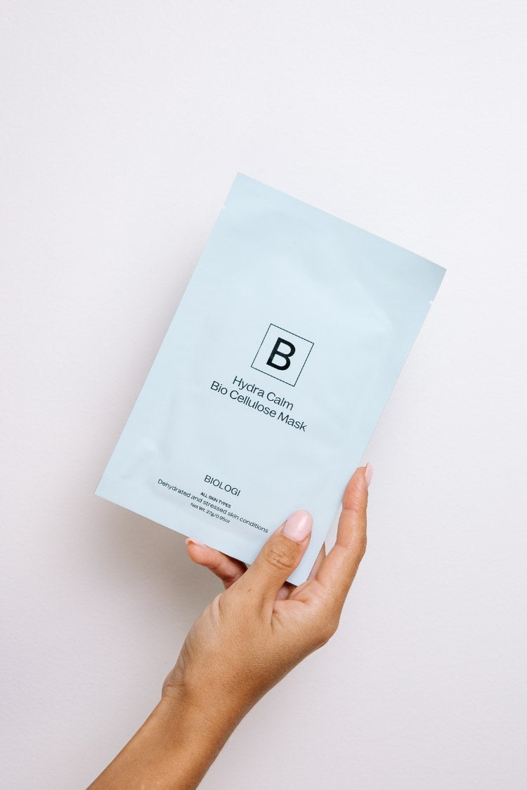 Hand holding the Hydra Calm Bio Cellulose Sheet Mask