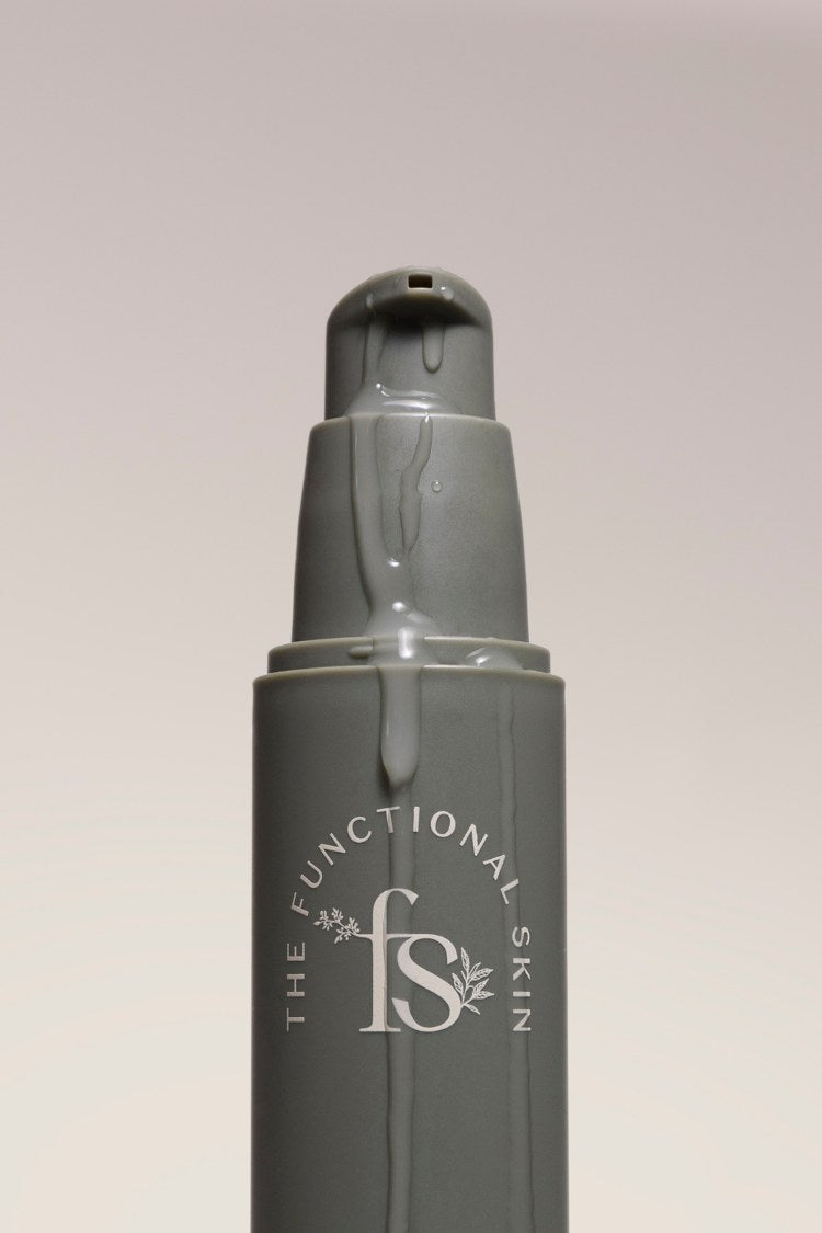 Skincare bottle with 'The Functional Skin' logo on a light gray background