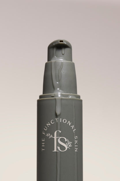 Skincare bottle with 'The Functional Skin' logo on a light gray background
