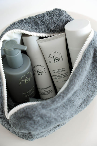 Cosmetic bag with skincare products on a white background