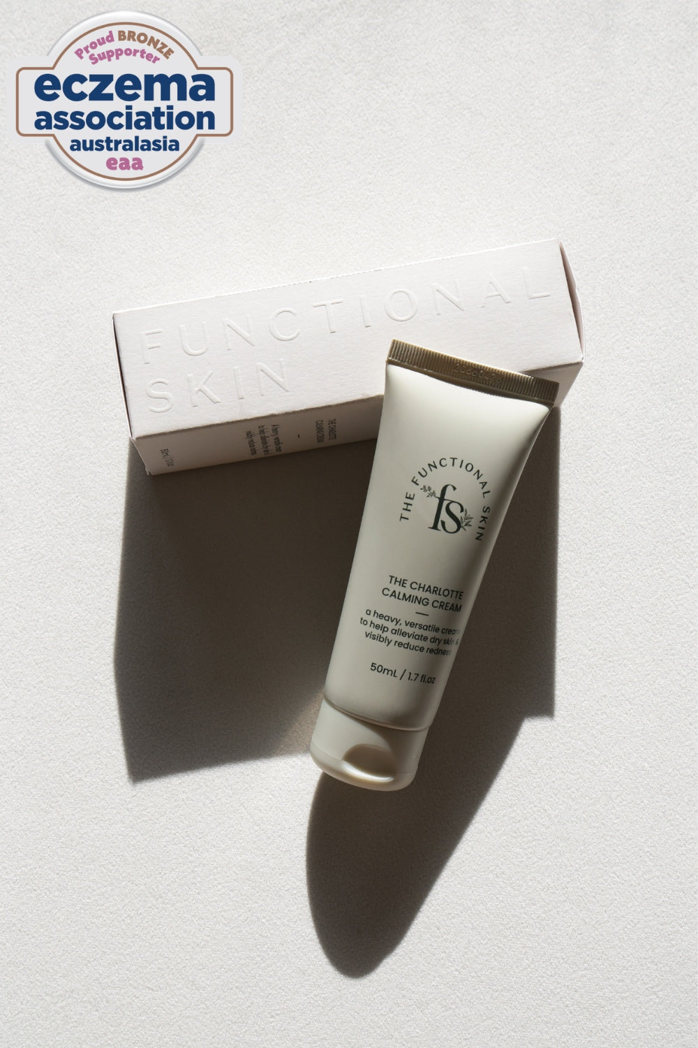 Tube of cream with packaging on a white background, featuring the Eczema Association Australasia logo.