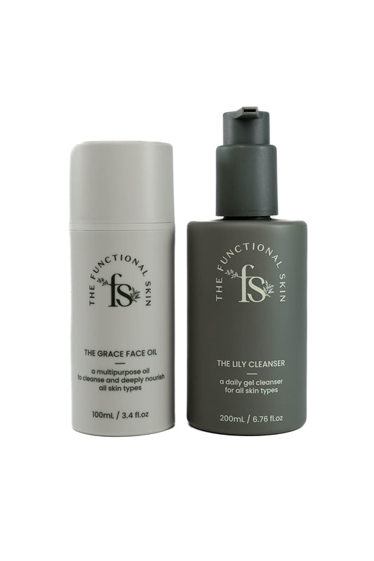 Two skincare products, 'Grace Face Oil' in a white bottle and 'Lily Cleanser' in a dark green bottle, from The Functional Skin.